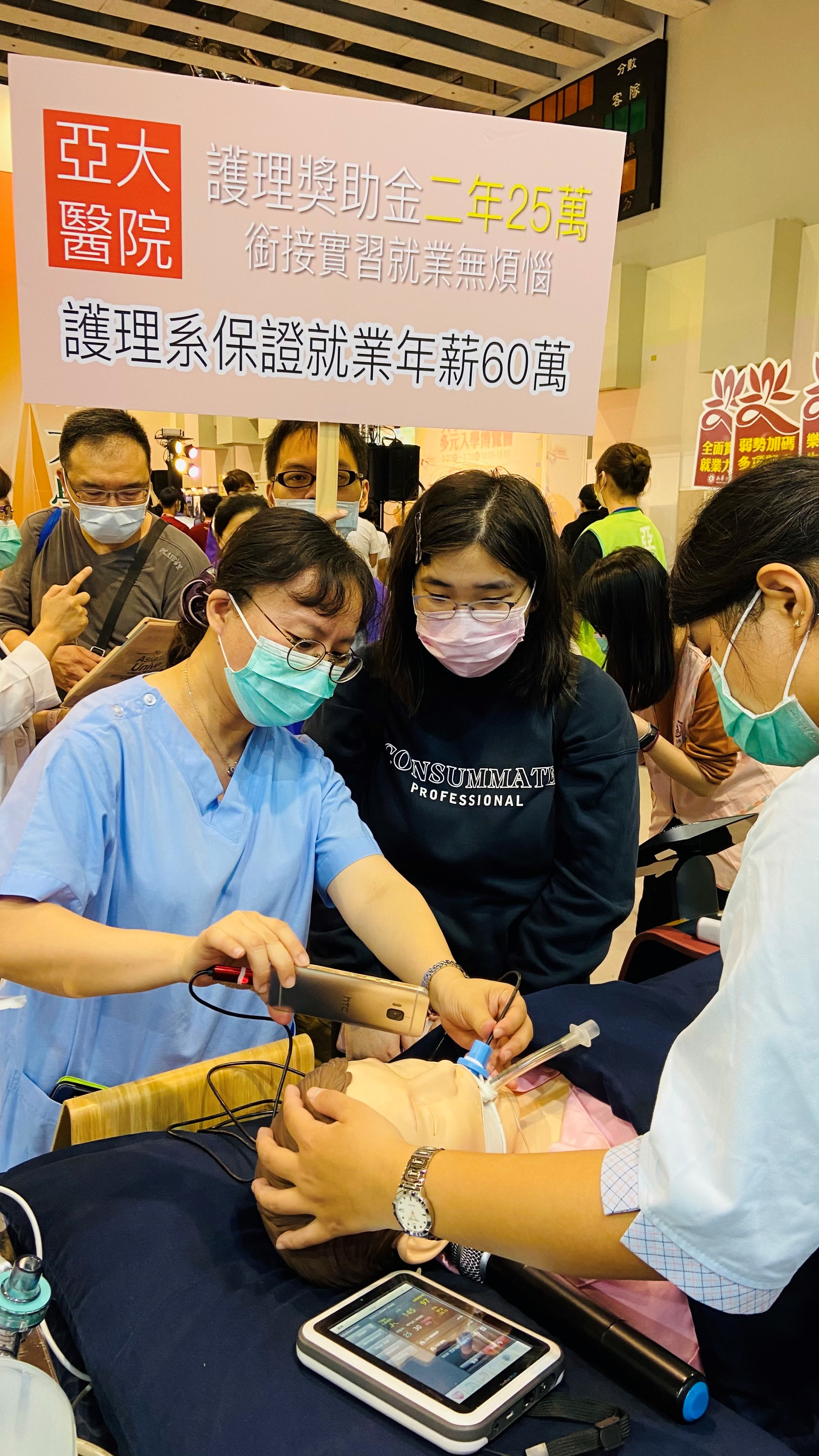 亞大護理學院在大博會展現智慧高階模擬病人的緊急救護,吸引很多考生的興趣與圍觀。