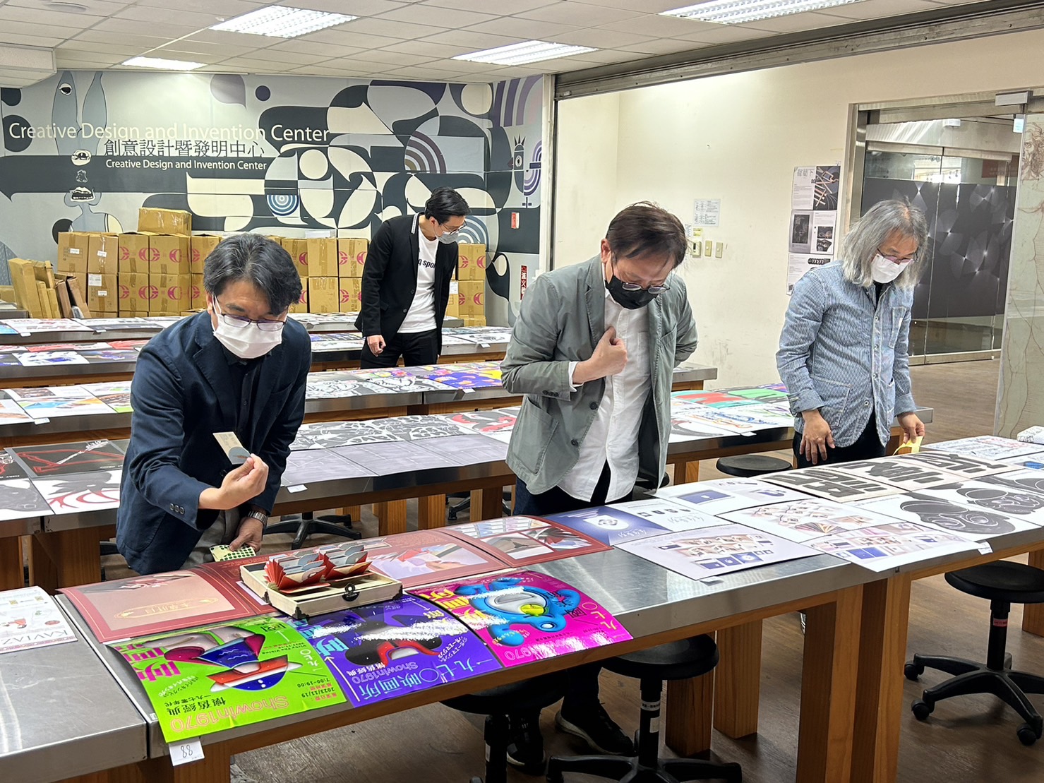 圖為4位評審在「2023紅點傳達校外審查活動」現場,進行作品評比。