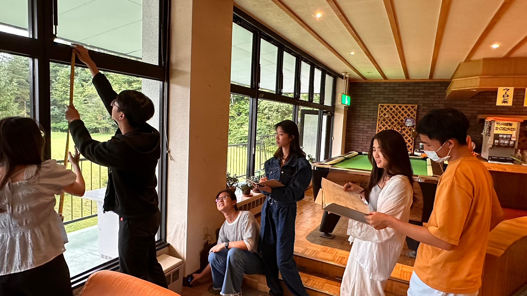 圖為亞大室設系同學,在飯店丈量尺寸。