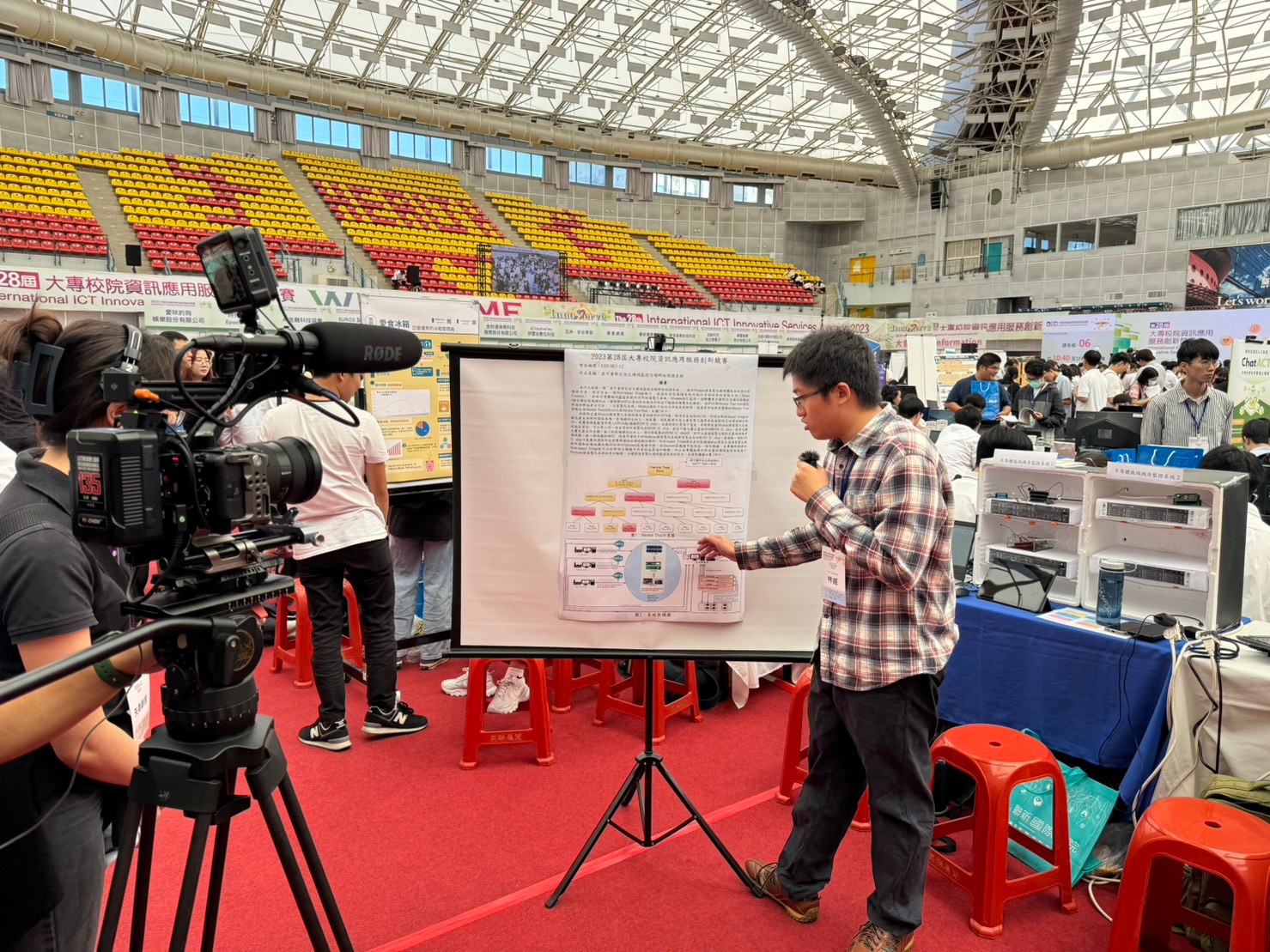 圖為亞大資工系同學,在比賽中向採訪團隊詳述其參賽作品。