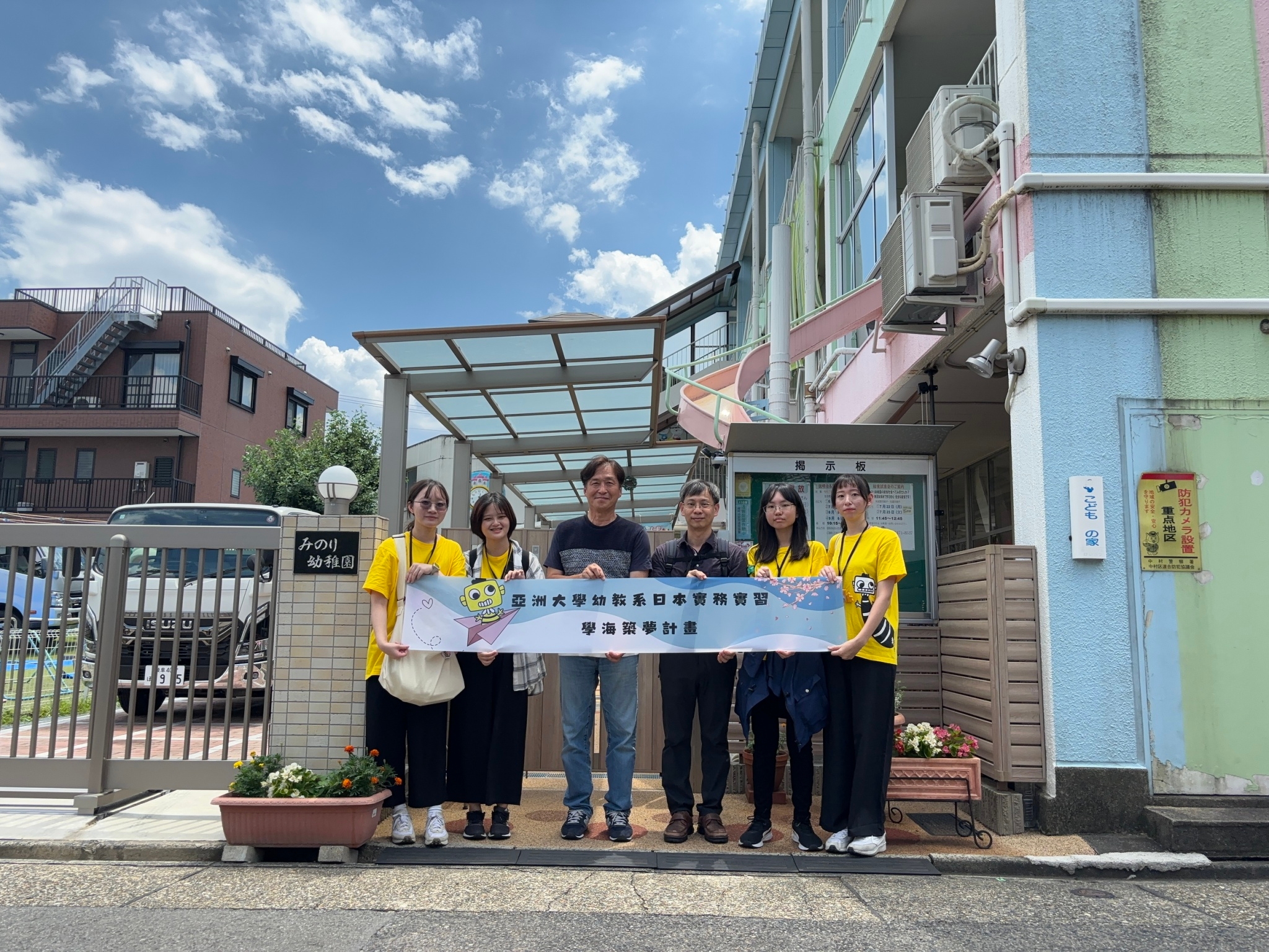 圖為亞大幼教系指導老師林雍智(右3)、名古屋實幼兒園園長園長近藤義光(右4),和4位幼教系同學合影。